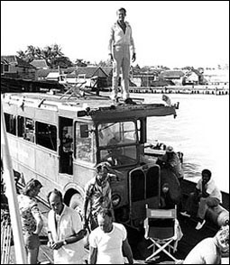 Roger Moore atop 'single-decker' - shooting Live And Let Die (1973)