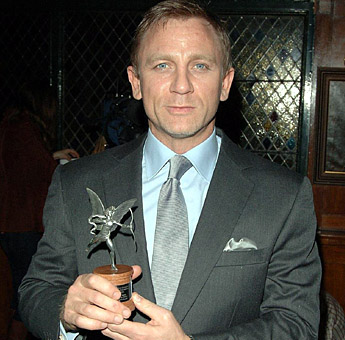 Daniel Craig proudly displays his BEST ACTOR award from the EVENING STANDARD