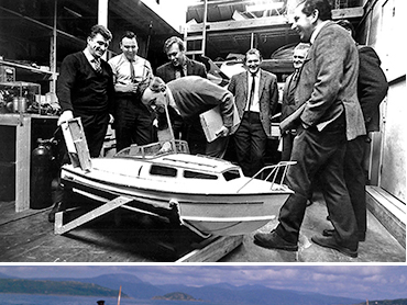 John Stears shows off a radio-controlled model of a Fairey Huntress motor boat to colleagues at Pinewood Studios