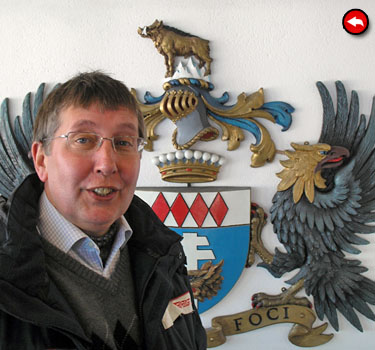 Fred in front of Syd Cain's Blofeld Coat of Arms at Piz Gloria