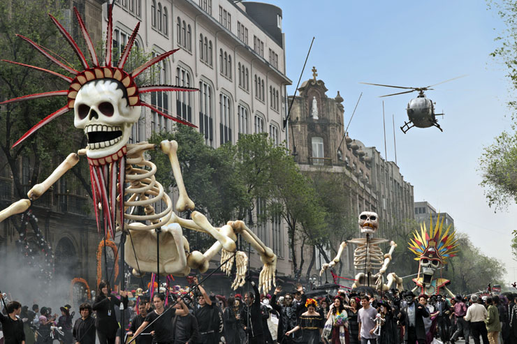 Bond chases Sciarra through the Day of the Dead parade in Mexico City. Scairra's helicopter swoops in to collect him in