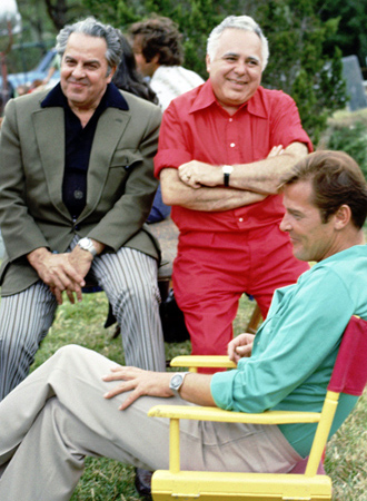Albert R. Broccoli & Harry Satzman with Roger Moore on the set of Live And Let Die (1973)