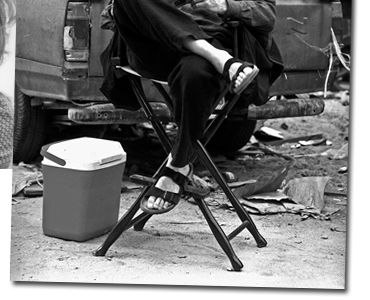 Pierce Brosnan relaxes between takes on Tomorrow Never Dies (1997)