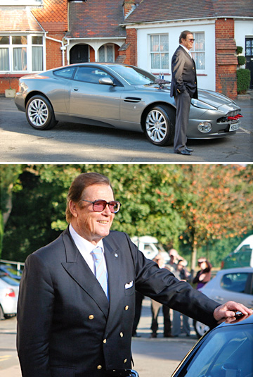 Sir Roger Moore poses with Aston Martin DBS at Bletchley Park