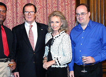 Sir Roger and Lady Moore flanked by artist Delmo Walters Jr. and OHMSS scholar Charles Helfenstein